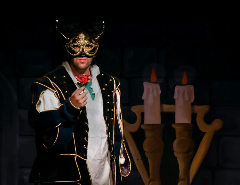 man in beast mask holding rose