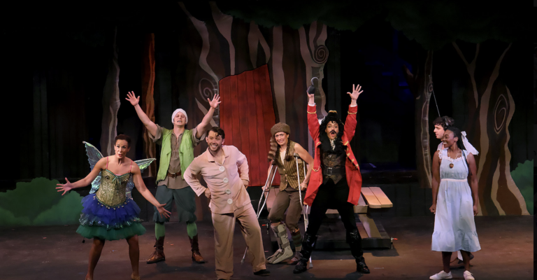 characters from Peter Pan stand triumphantly in a pose